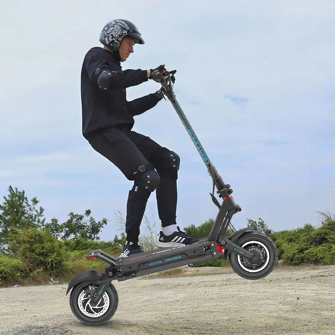 Person riding a scooter outdoors with a clear sky and greenery in the background