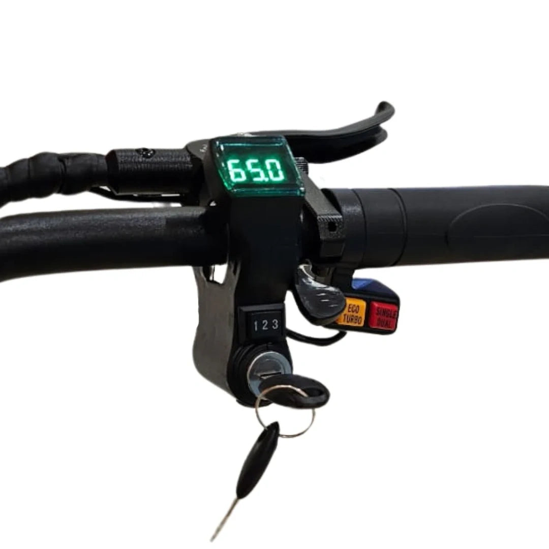 Close-up of a motorcycle handlebar with digital speedometer and key fob on a white background