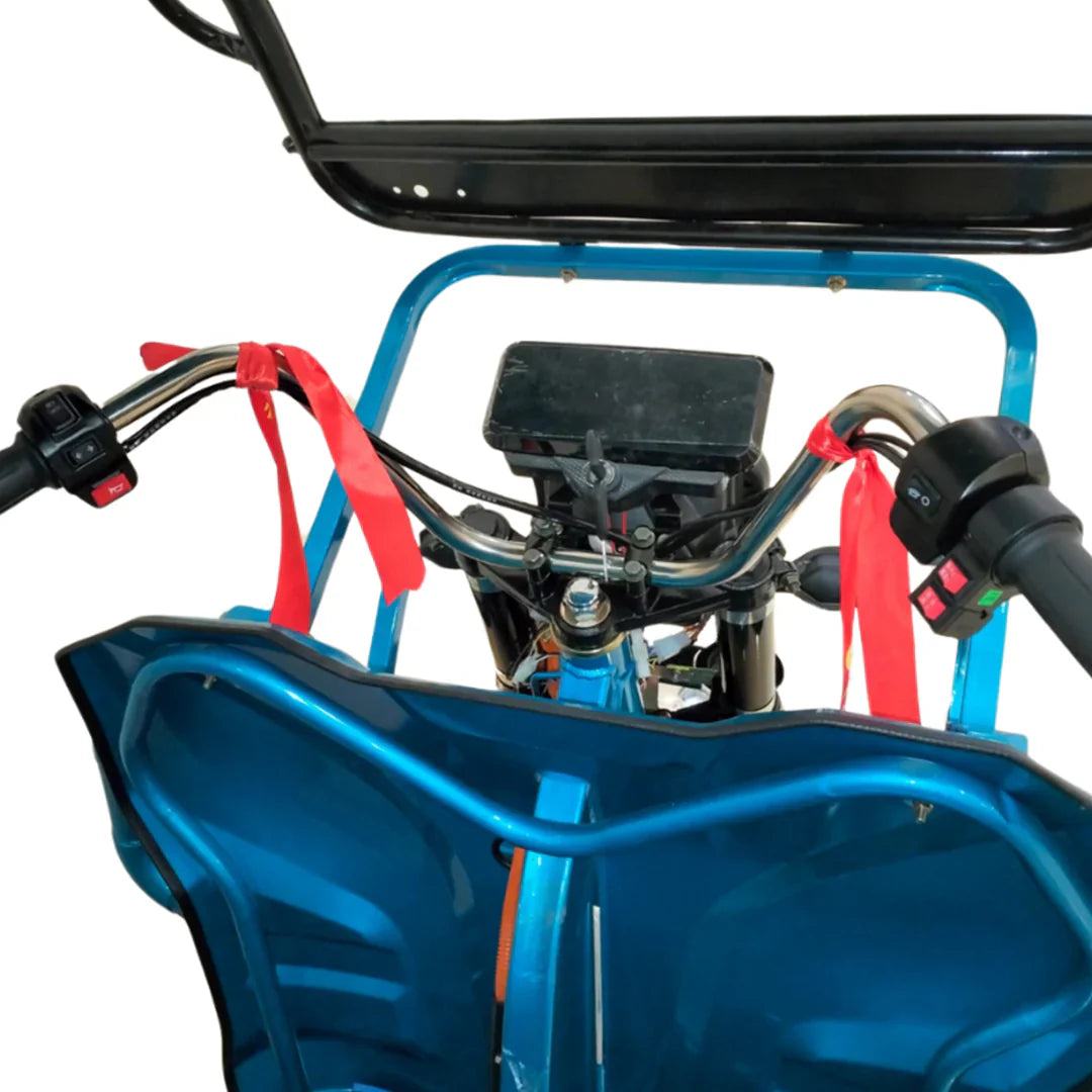 Close-up of a blue vehicle's engine and handlebars on a white background