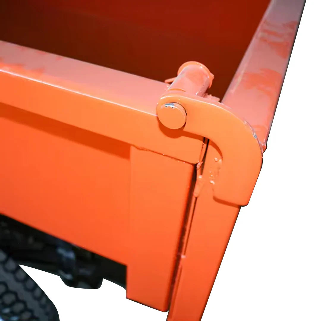 Close-up of an orange metal dump cart on a white background
