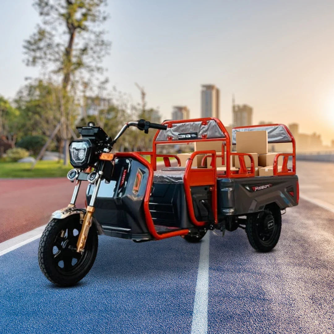 Three-wheeled electric vehicle with cargo bed on a road with cityscape in the background