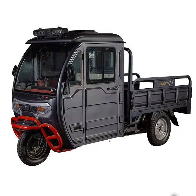 Black three-wheeled vehicle with a cargo bed on a white background