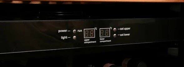 Control panel of a kitchen appliance with digital displays and buttons.