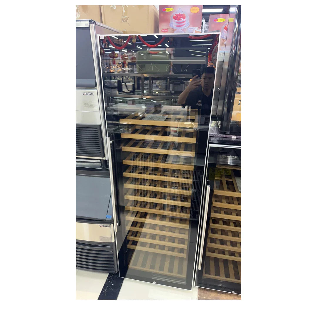 Wine cooler with open door displaying wooden shelves in a store setting