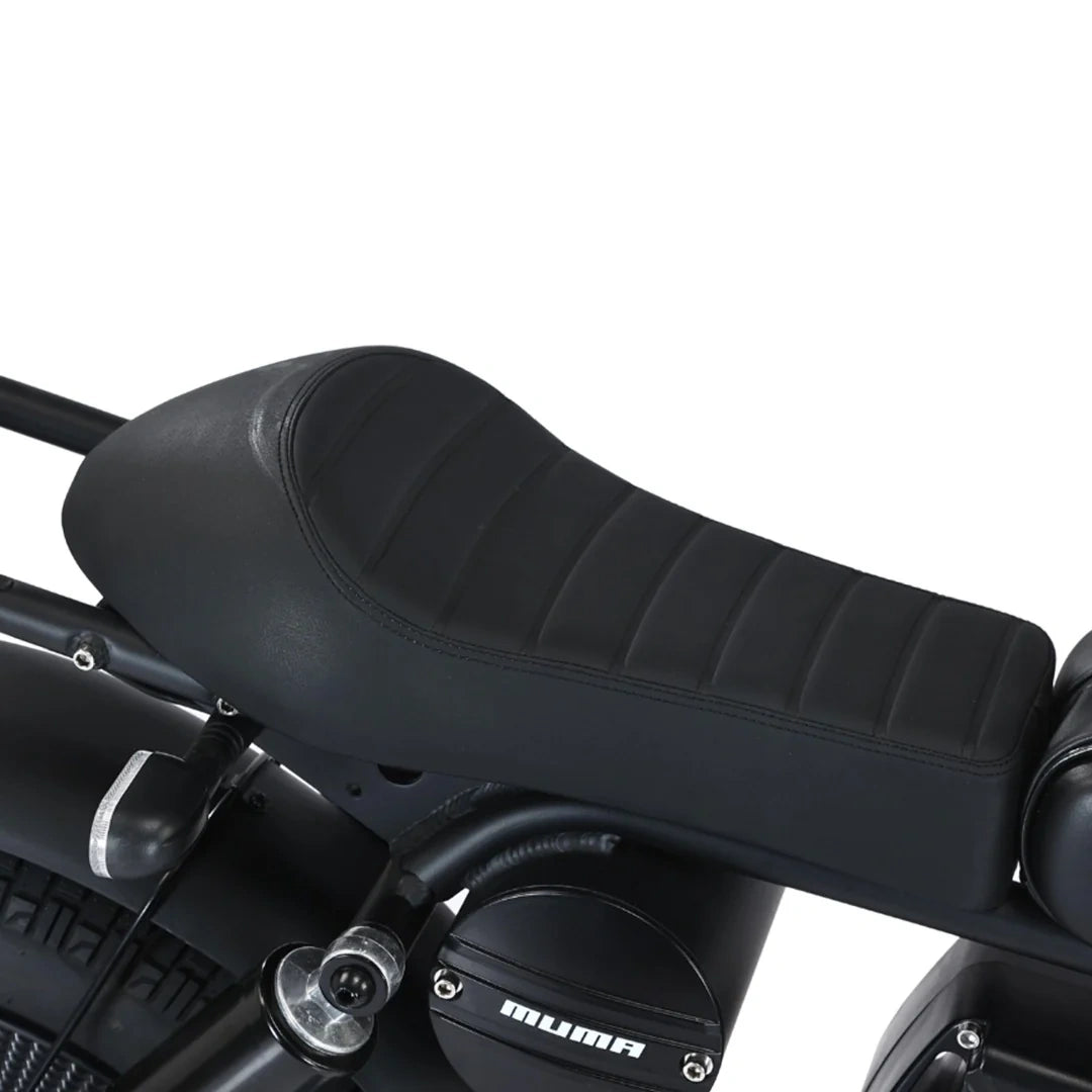 Close-up of a black motorcycle seat with 'Muma' branding on a white background