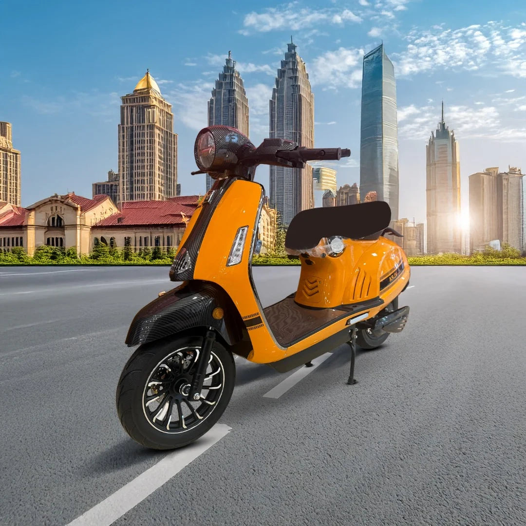 Orange scooter on a city street with tall buildings in the background