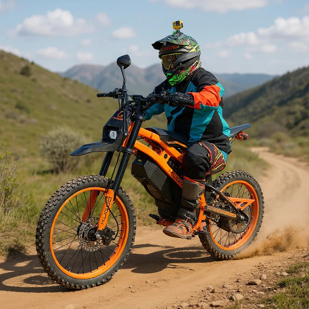Person riding an orange electric bike on a dirt trail with mountains in the background