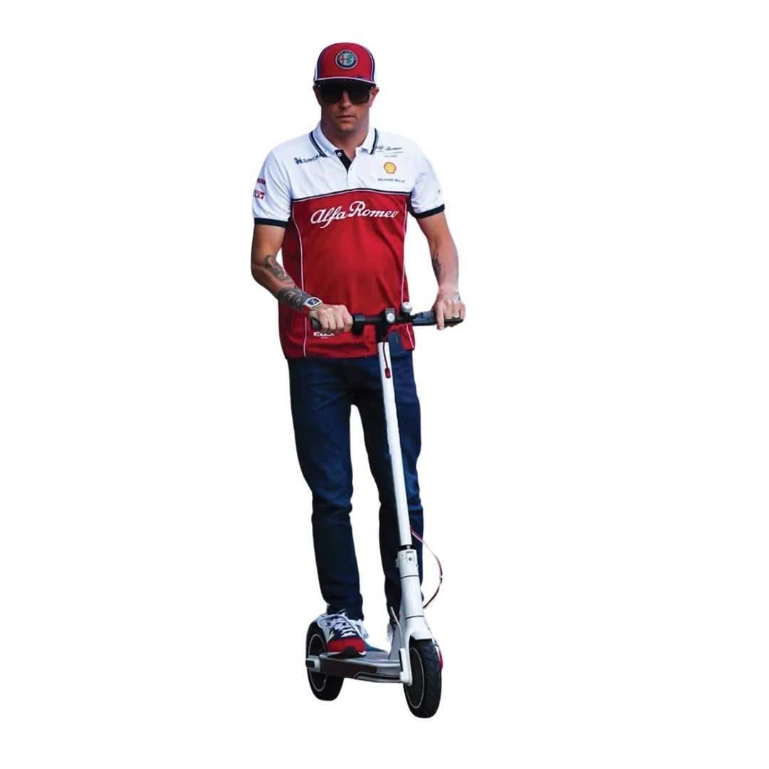 Person riding a scooter wearing a red and white racing outfit with 'Alfa Romeo' branding.