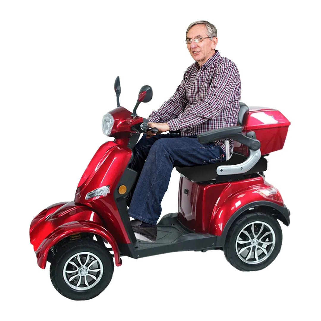 Man sitting on a red mobility scooter against a white background