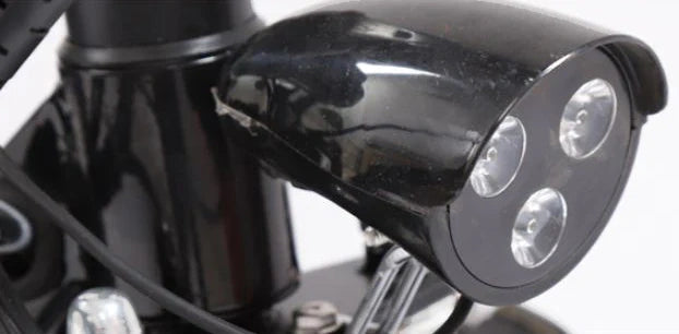 Close-up of a motorcycle mirror with multiple lights on a blurred background