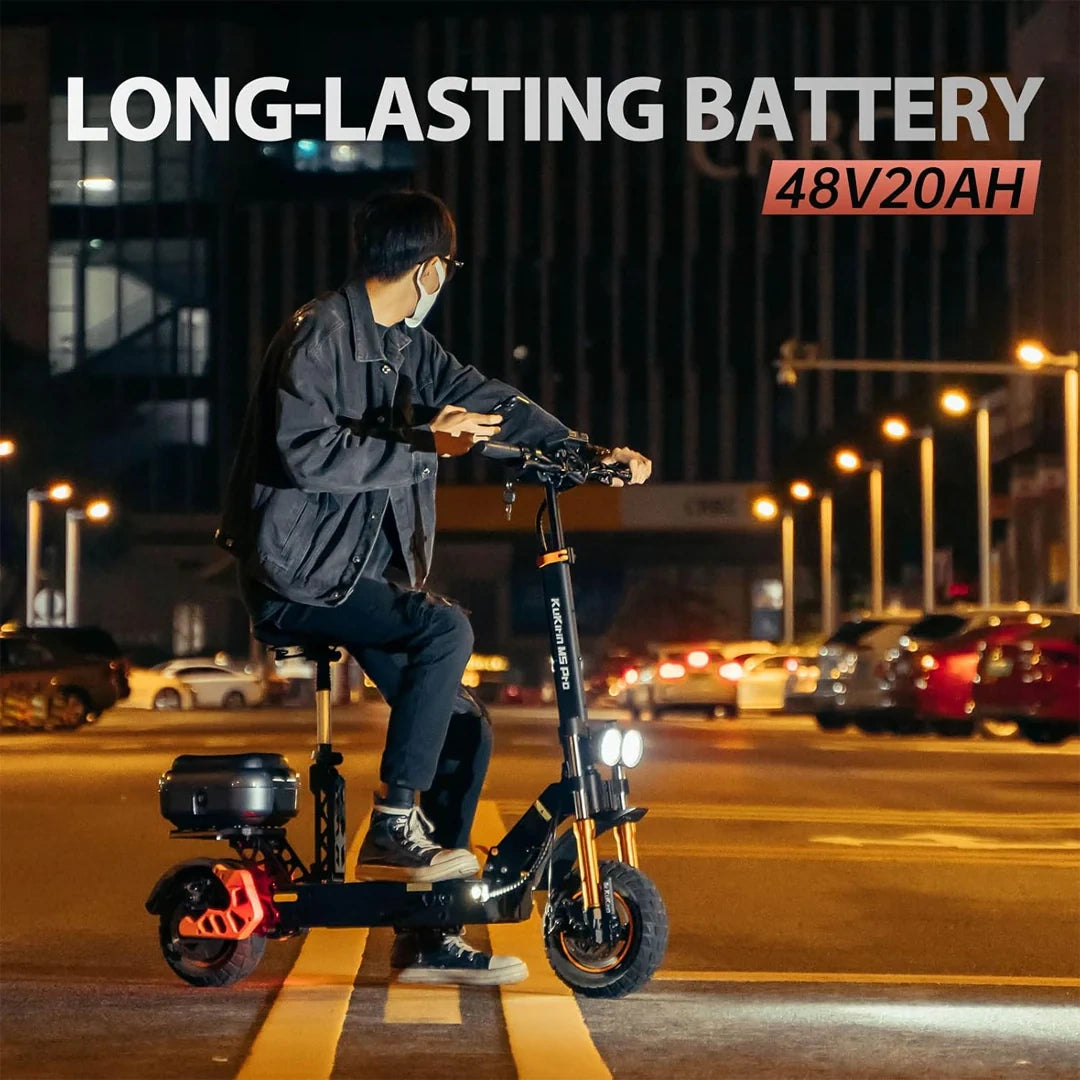 Person riding an electric scooter on a city street at night with 'LONG-LASTING BATTERY' text and specifications.
