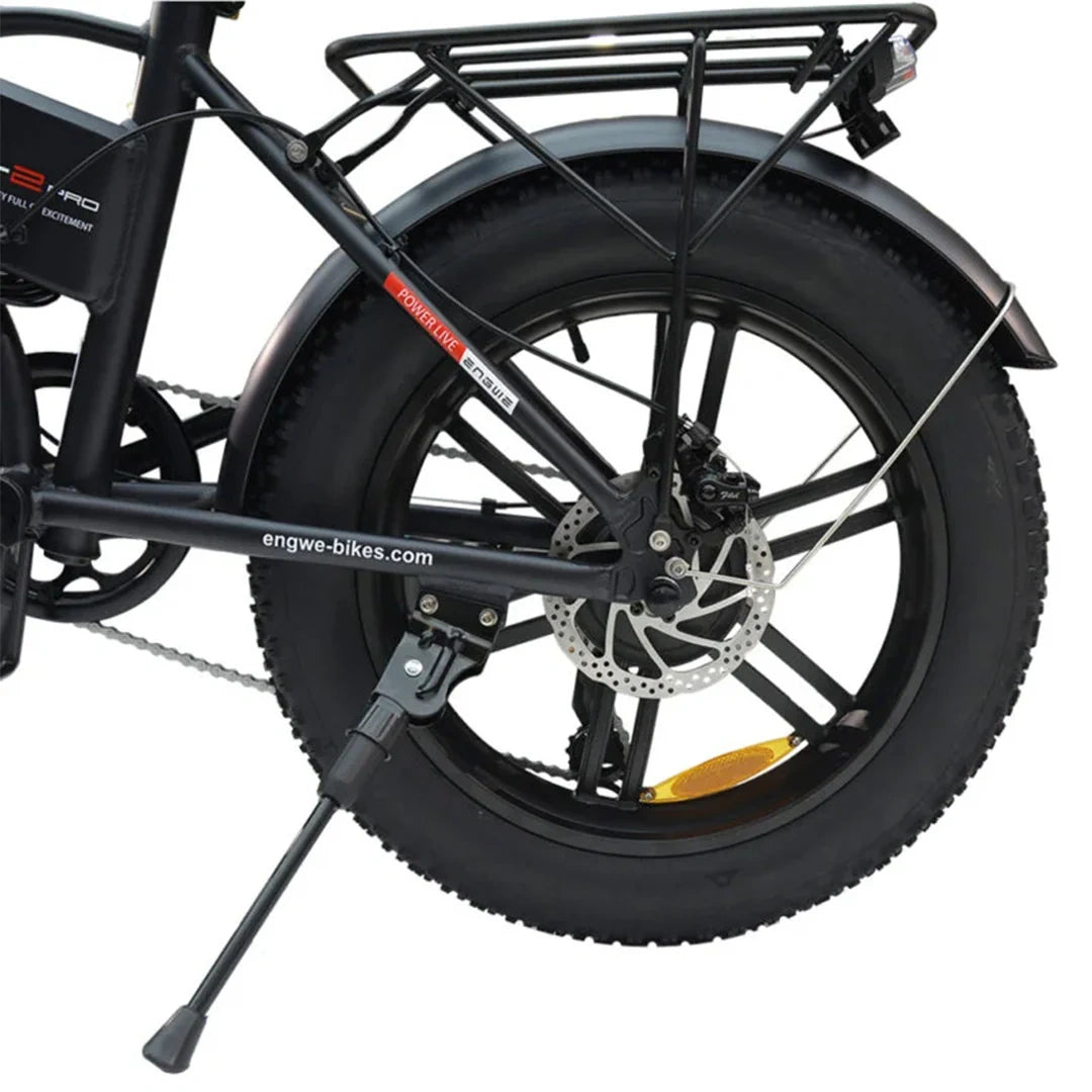 Close-up of a black electric bike wheel with visible branding on a white background