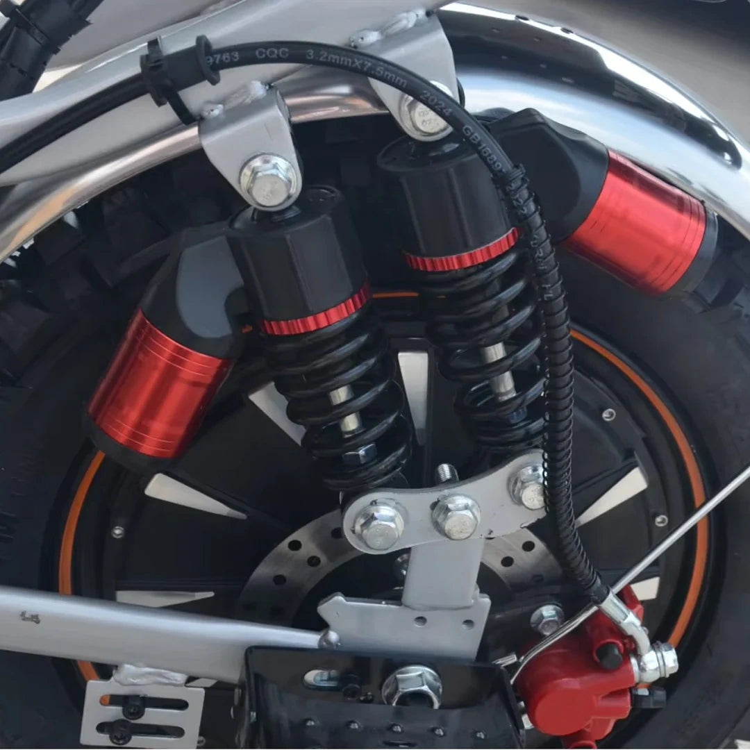 Close-up of a motorcycle suspension system with red accents