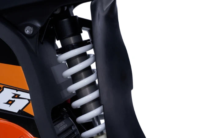 Close-up of a motorcycle suspension system with KTM branding on a white background