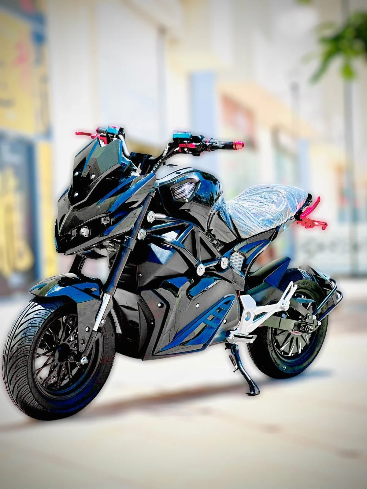 Toy motorcycle with blue and black design on a blurred indoor background