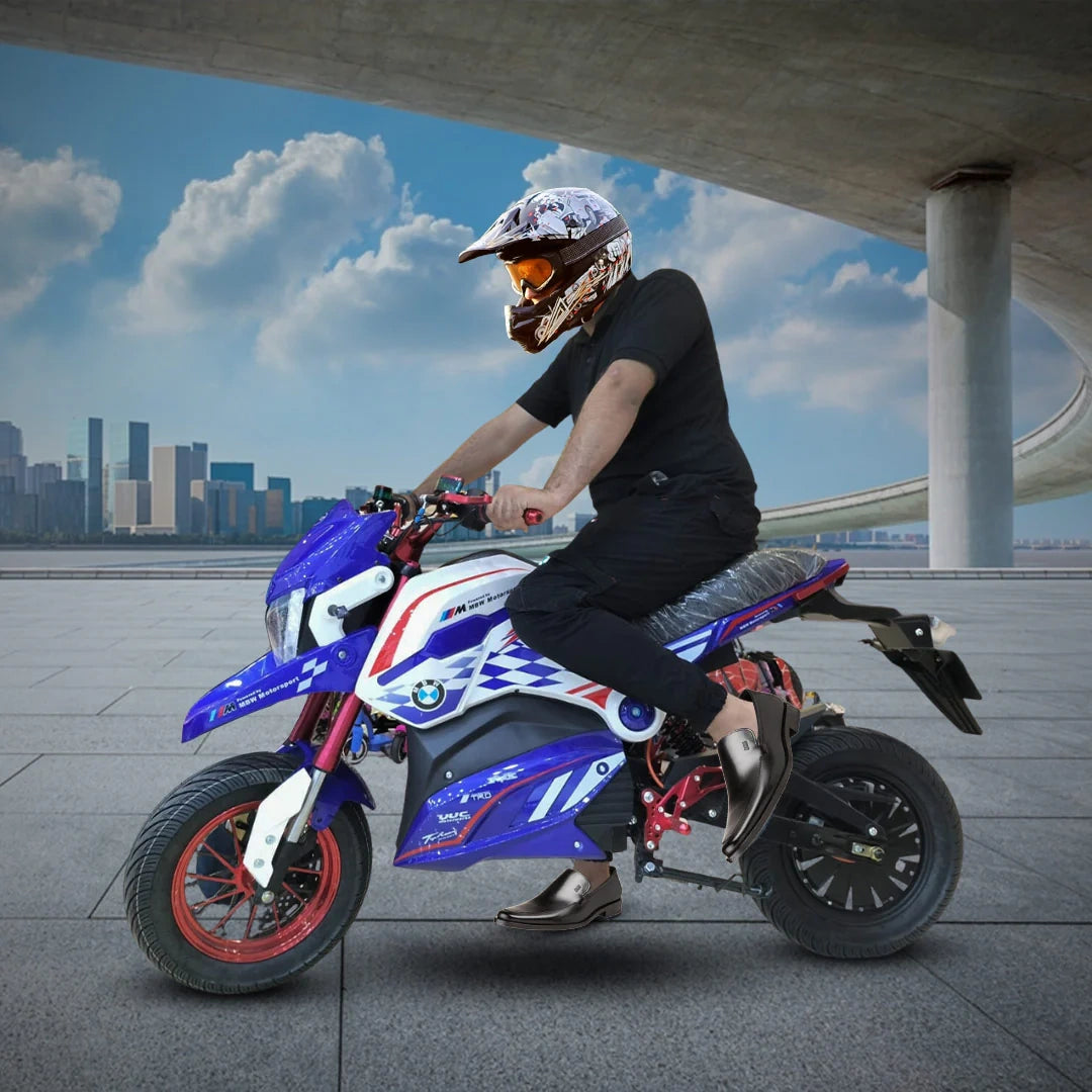 Person riding a blue and white motorcycle with a cityscape in the background