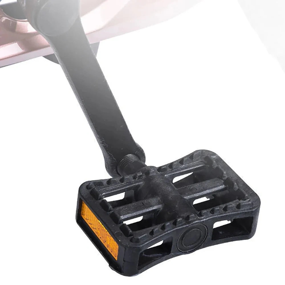 Black bicycle pedal with orange reflector on a white background