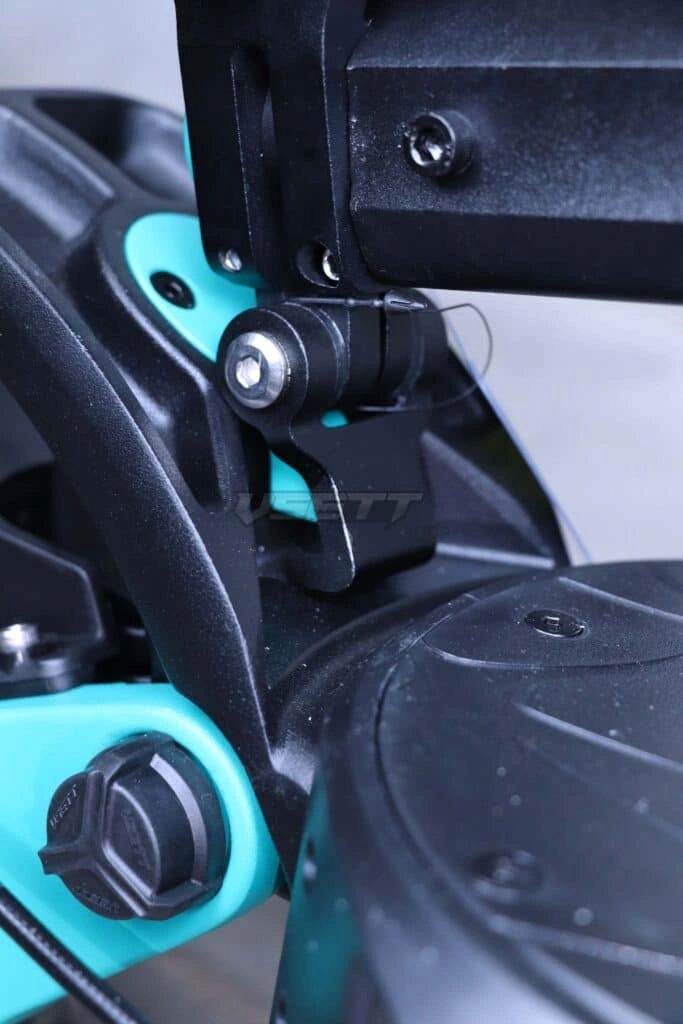 Close-up of a power tool with black and teal design