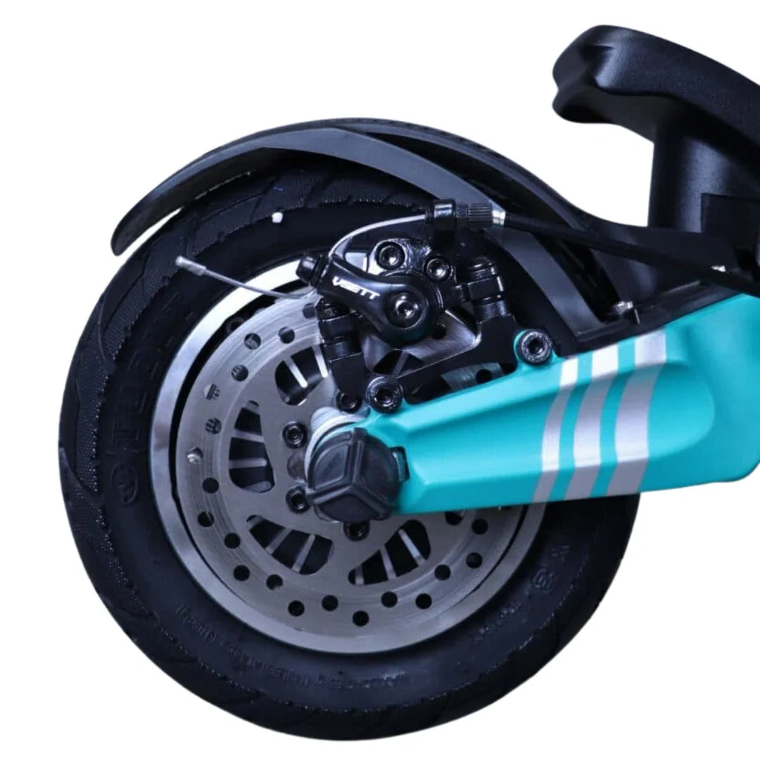 Close-up of a scooter wheel with turquoise frame and black tire on a white background