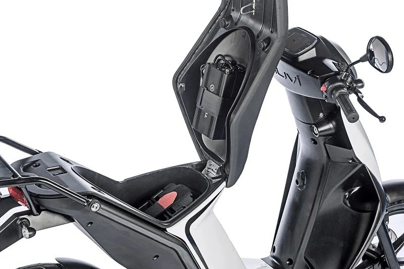 Close-up of a motorcycle seat and handlebar with 'Suzuki' branding on a white background