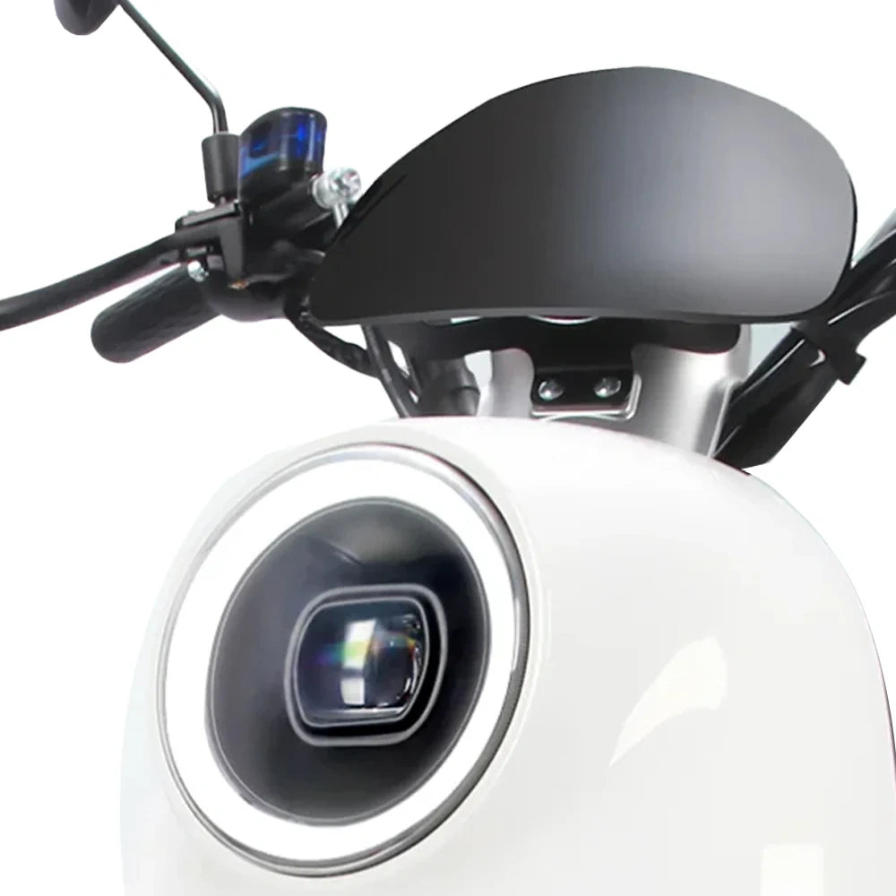 Close-up of a motorcycle's front camera and headlight on a white background