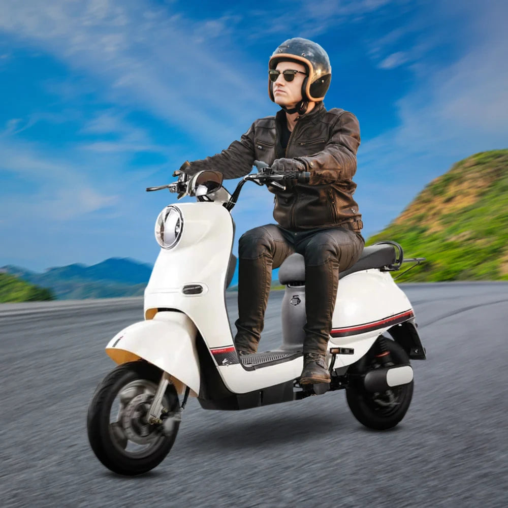 Person riding a white scooter on a road with a scenic background