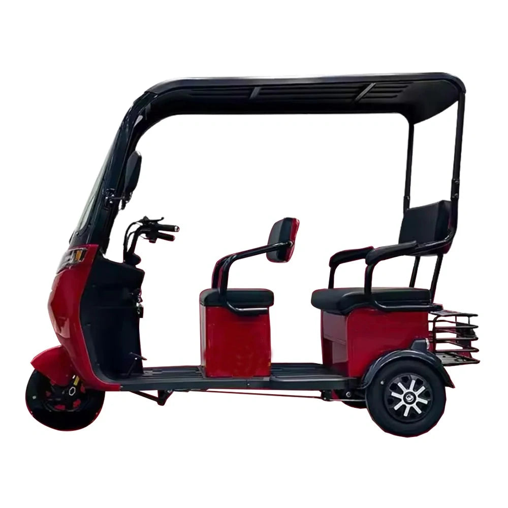 Red electric rickshaw with black seats on a white background