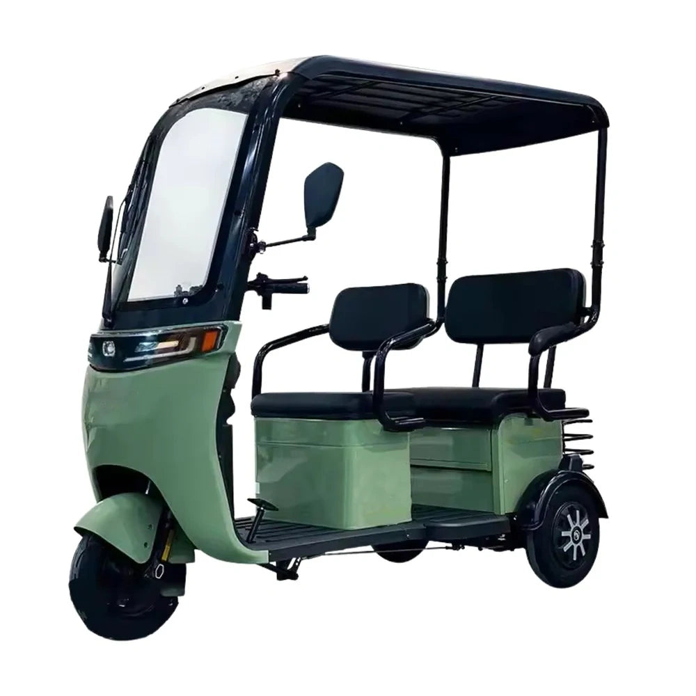 Green three-wheeled electric vehicle with a canopy on a white background
