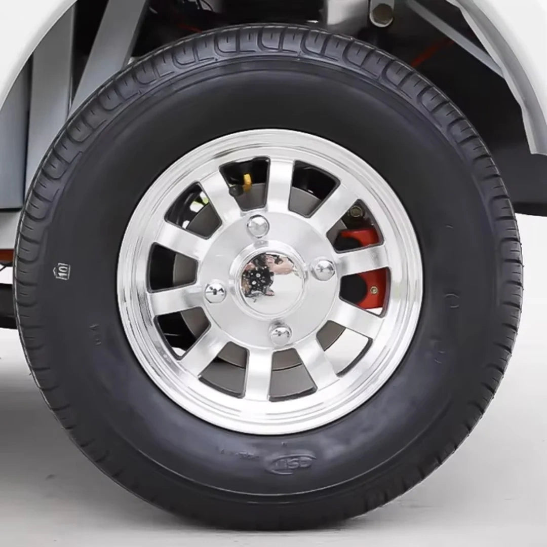Close-up of a car wheel with a silver rim and black tire on a white background