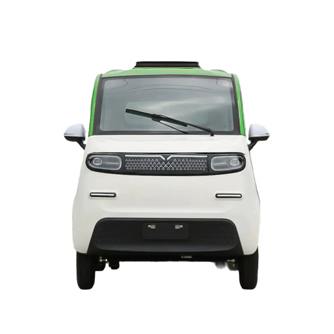 Front view of a small white car with green roof on a white background