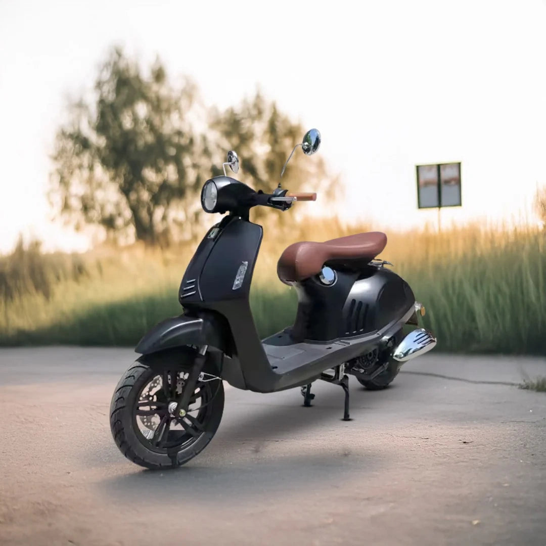 Black scooter parked on a road with a blurred natural background