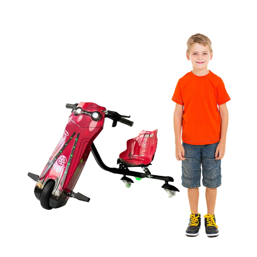 Child standing next to a red toy motorcycle on a white background