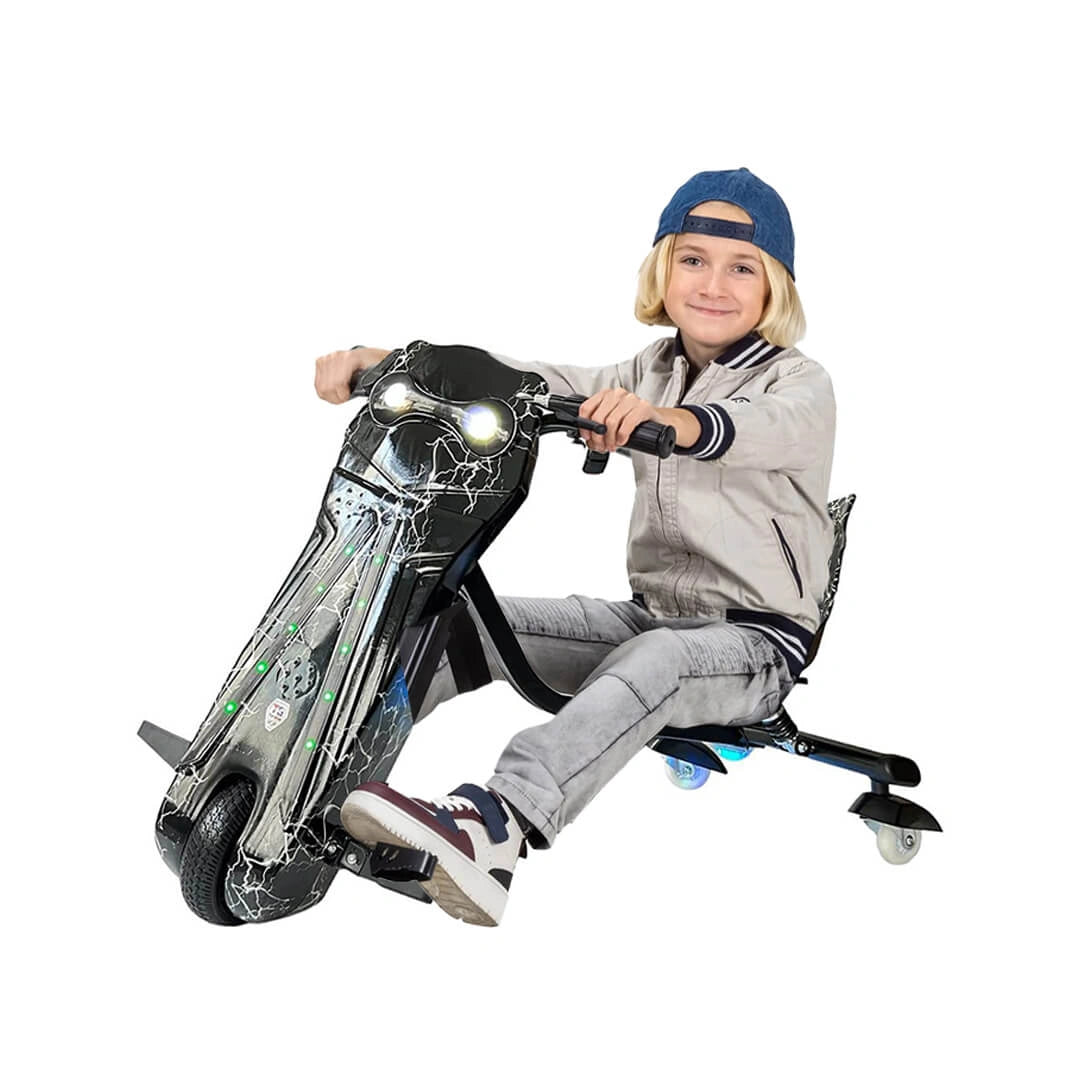 Child sitting on a toy motorcycle with lights on a white background