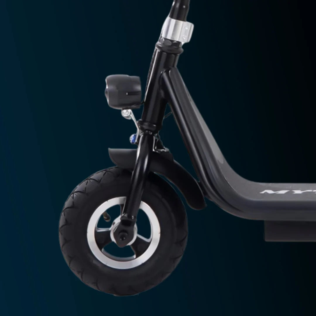 Close-up of a scooter wheel and handlebar on a dark background