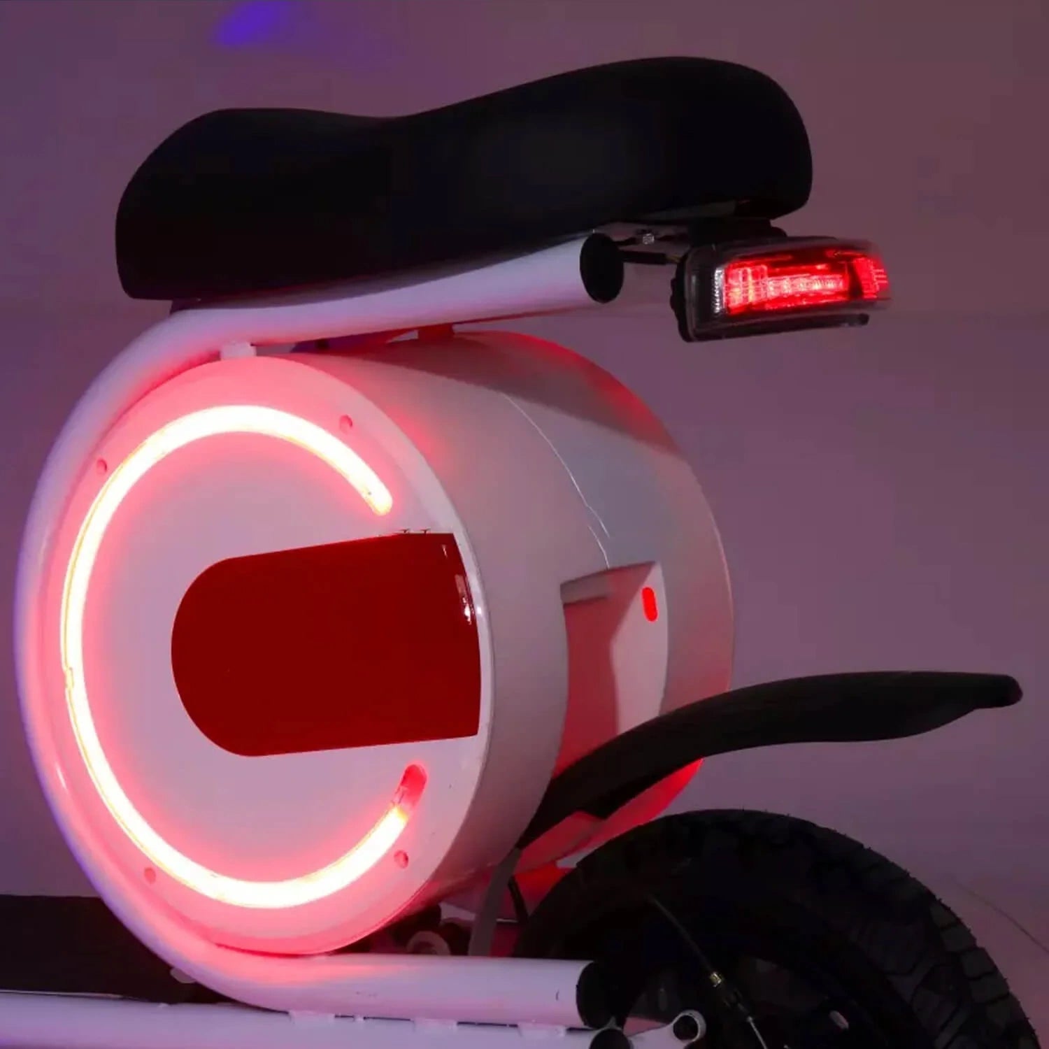 Close-up of a bicycle with a glowing red light on a dark background
