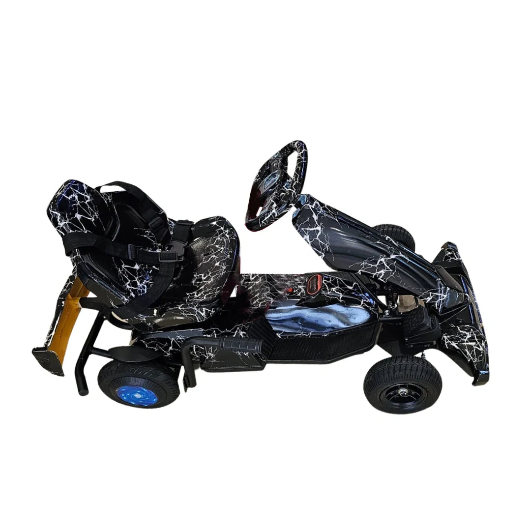 Black and gray go-kart with a helmet on a white background