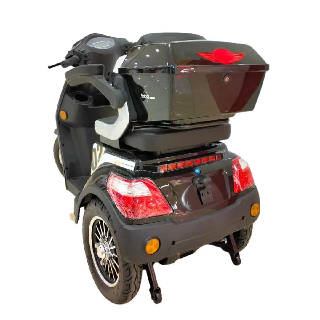Black mobility scooter with a red light on a white background