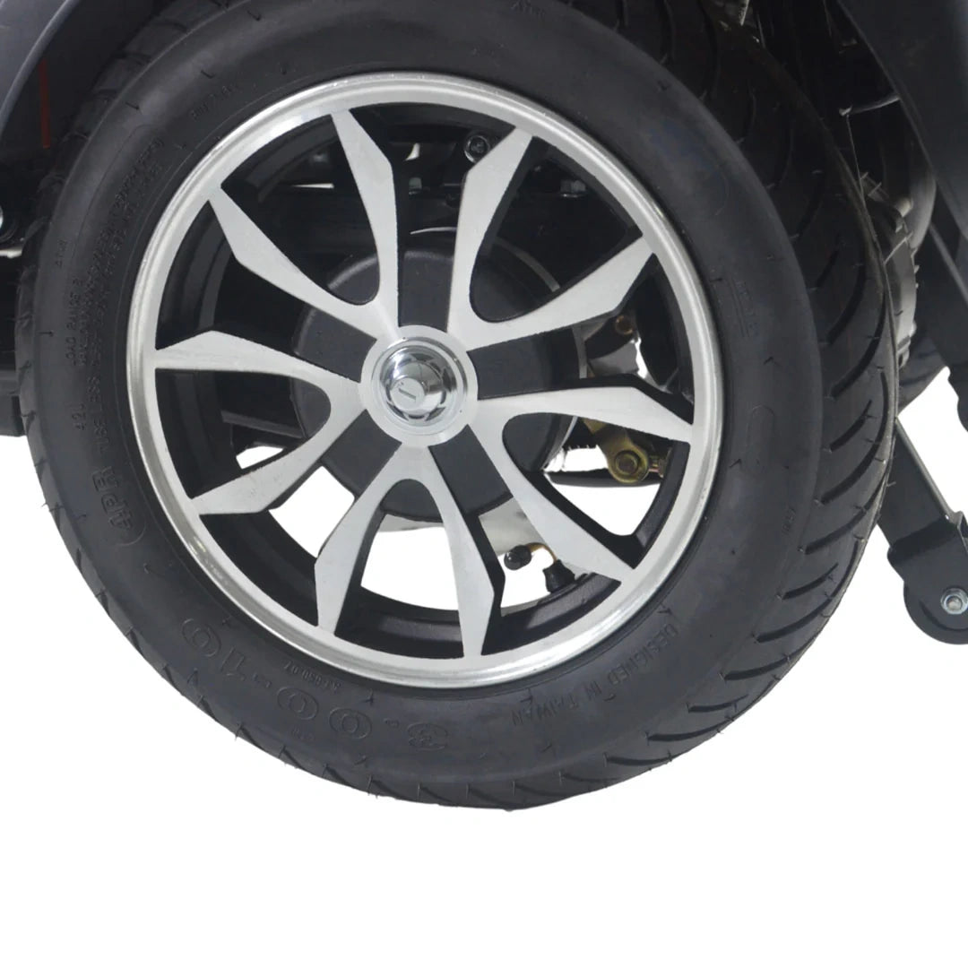 Close-up of a car wheel with a black tire and silver alloy rim on a white background