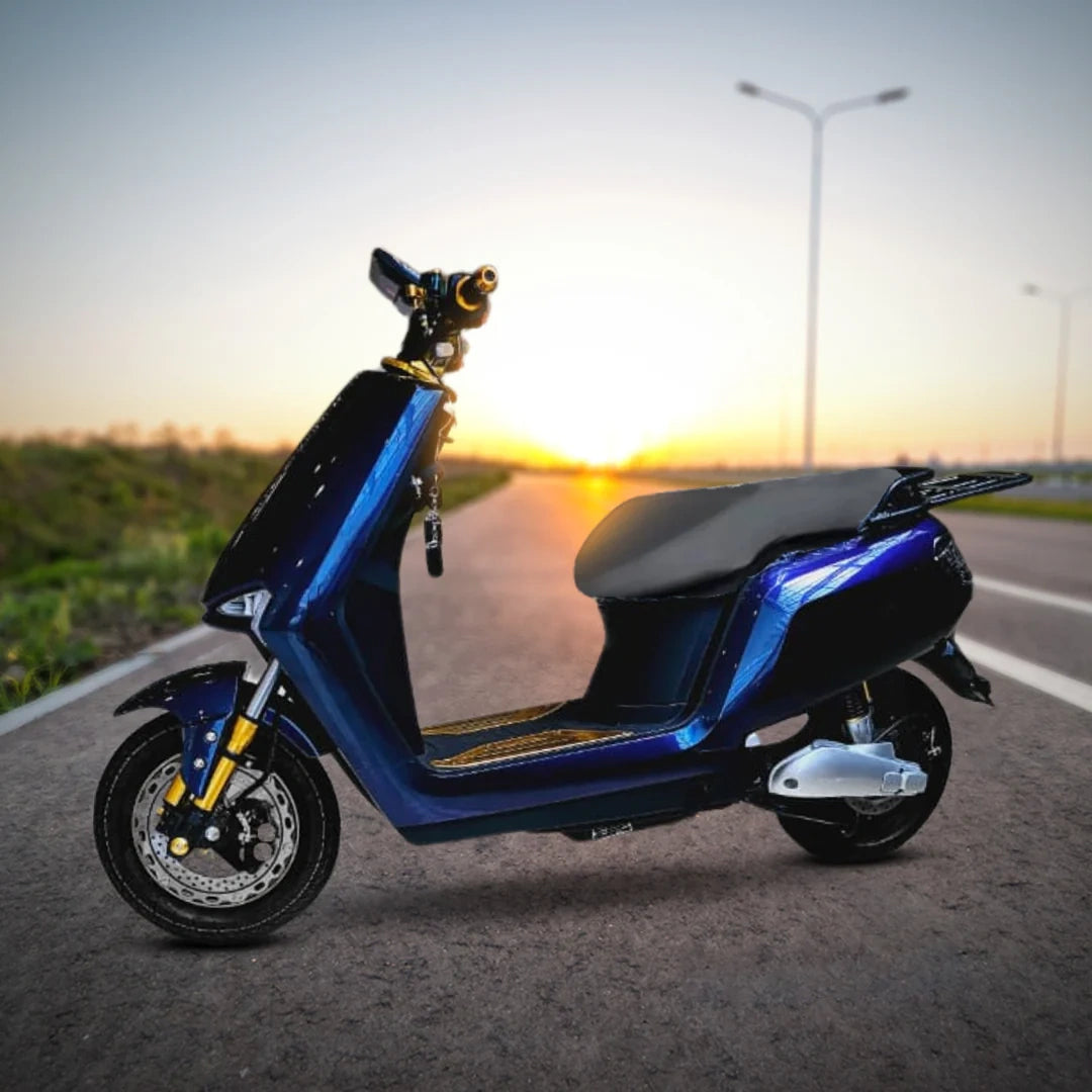 Blue electric scooter on a road with a sunset in the background