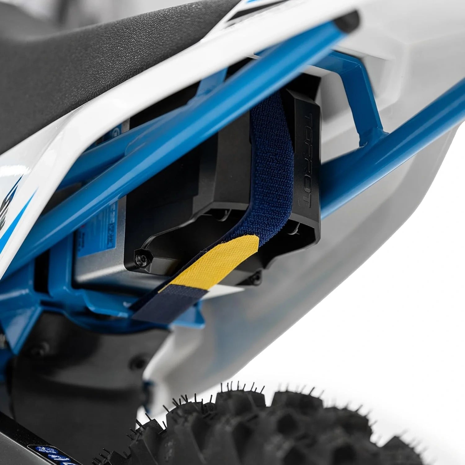 Close-up of a blue and white snowmobile with a black seat and yellow accent on a white background.
