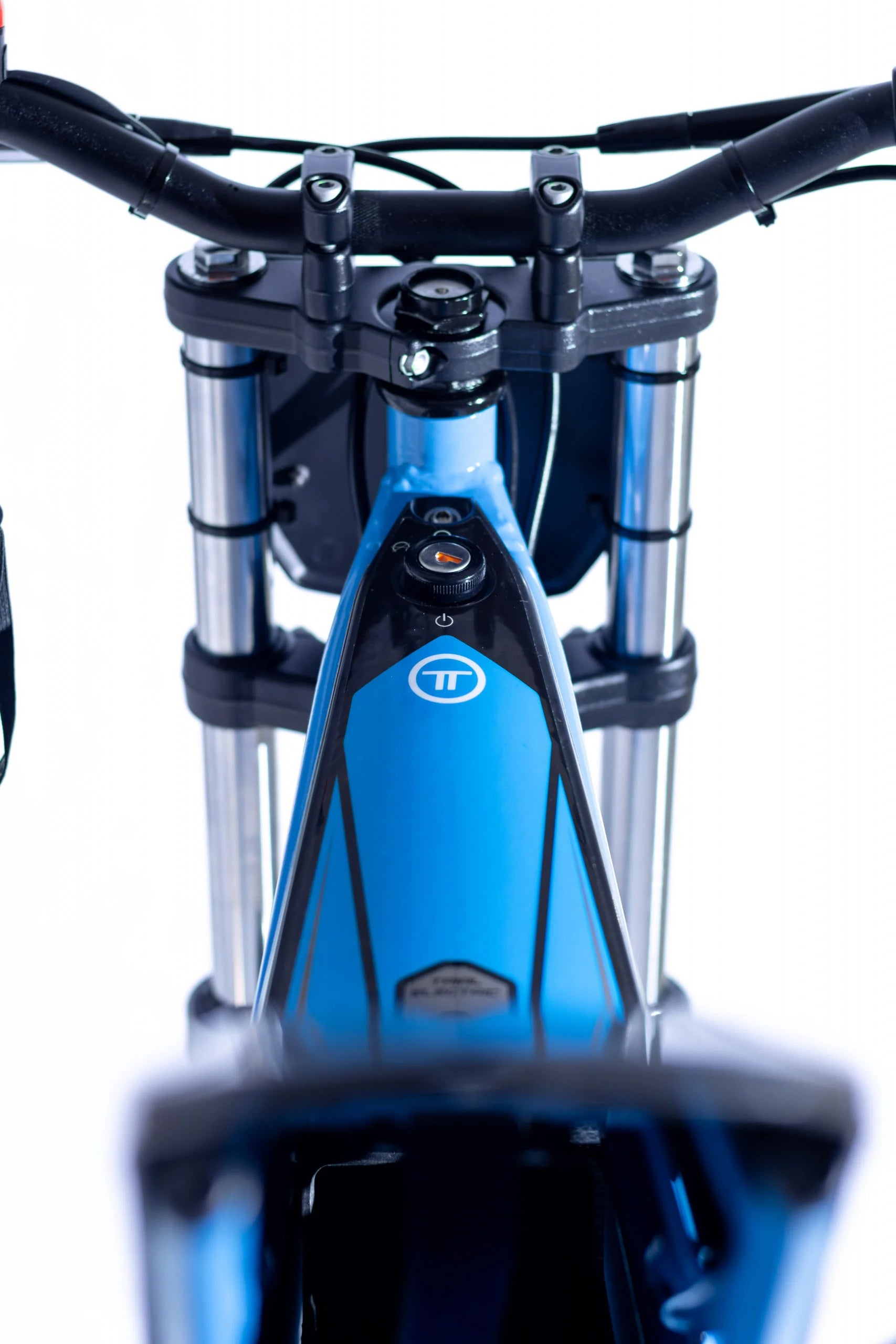 Close-up of a bicycle's front suspension fork with a brand logo on a white background