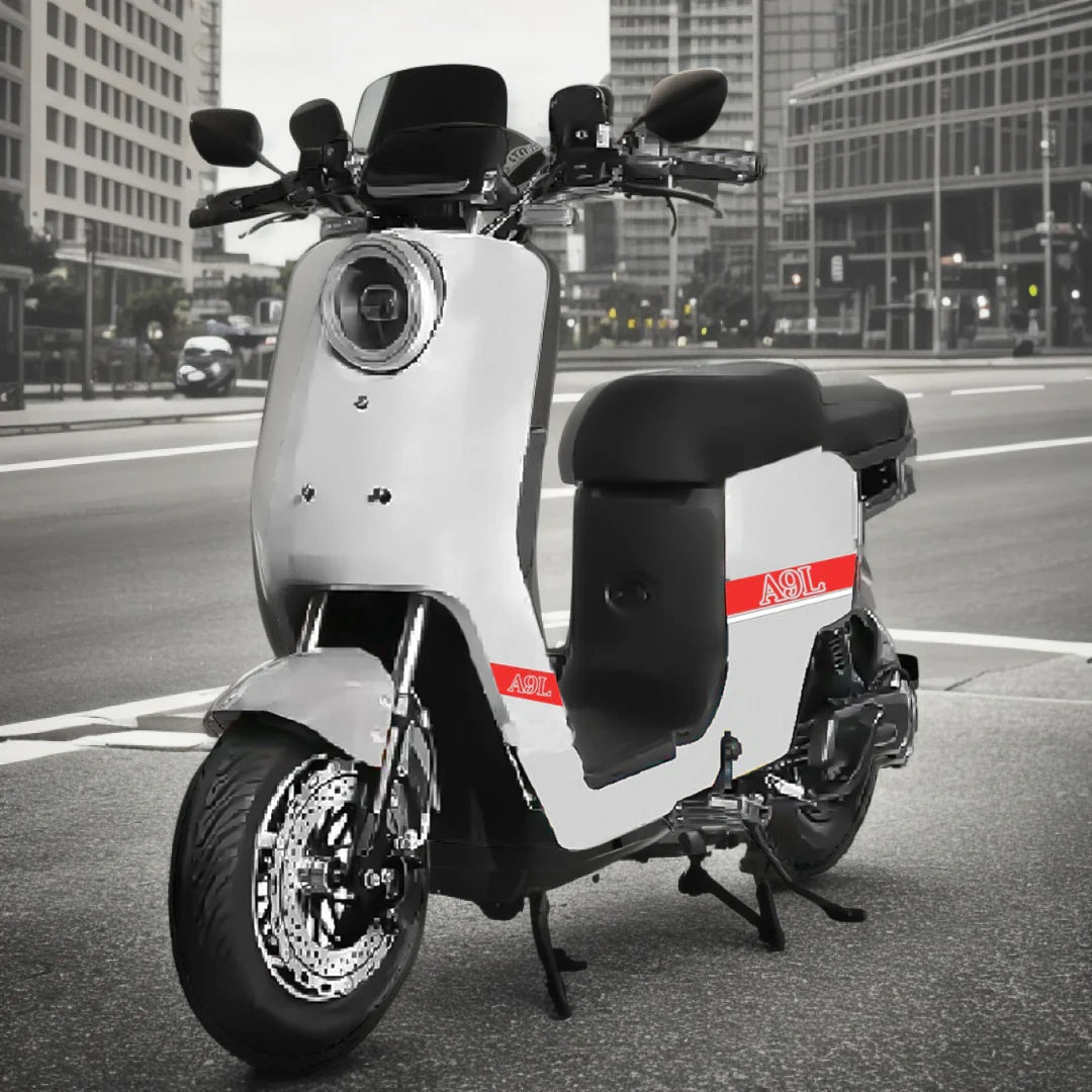 White electric scooter with red accents on a city street