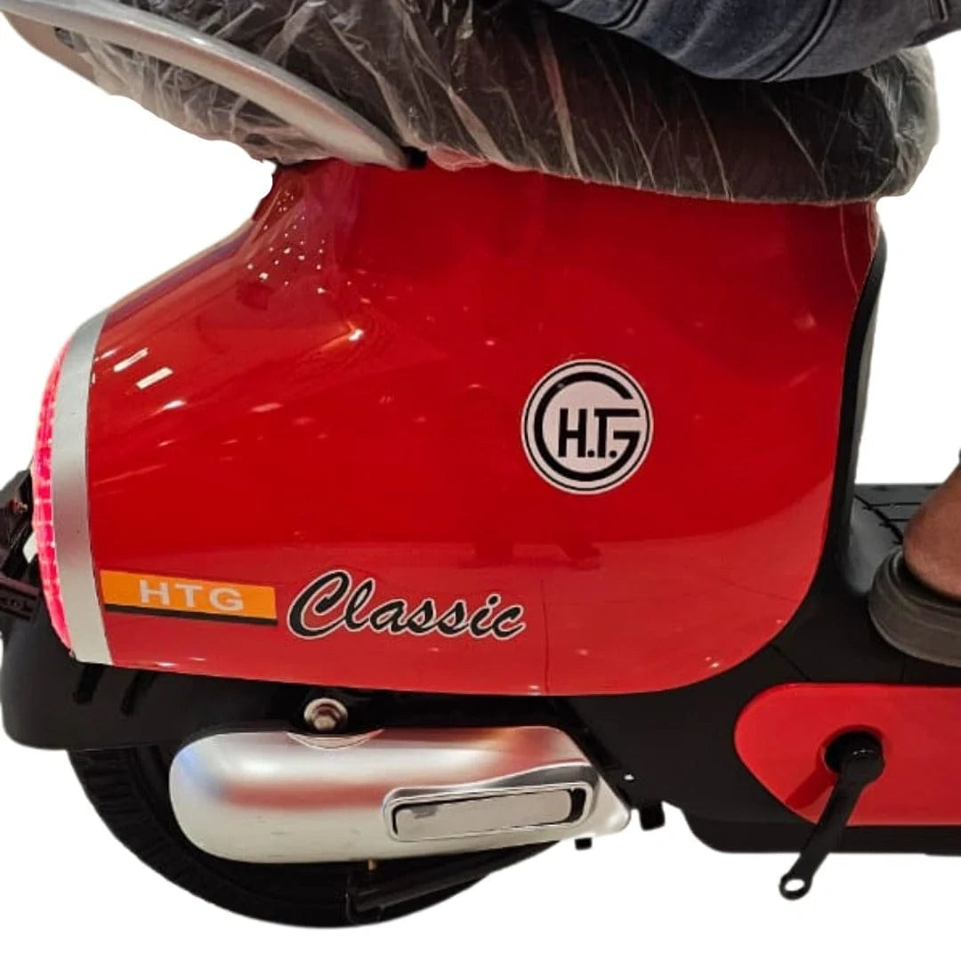 Close-up of a red scooter with 'H.T.' logo on a white background