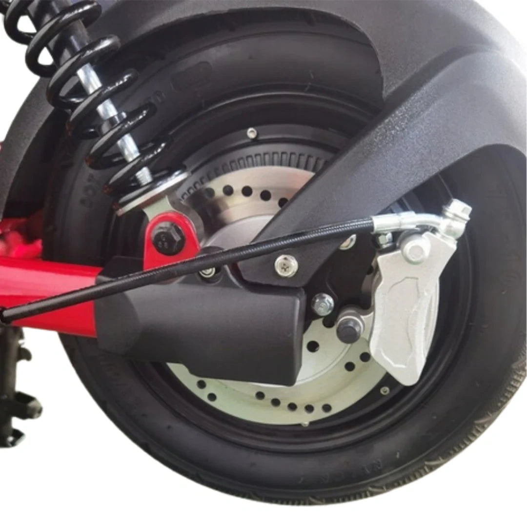 Close-up of a motorcycle wheel with suspension and brake components on a white background