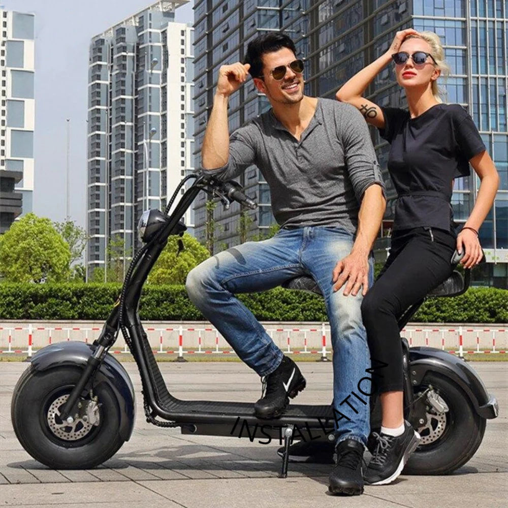 Two people riding a black electric scooter in an urban setting.
