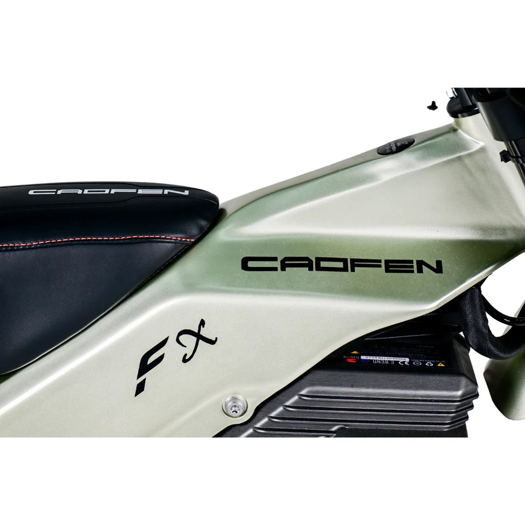 Close-up of a Cadfen motorcycle with branding on a white background
