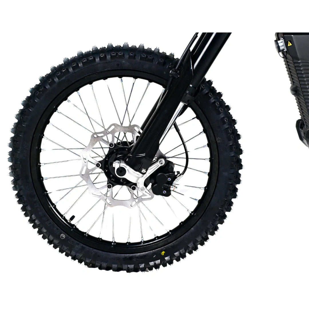 Close-up of a bicycle wheel with knobby tires on a white background