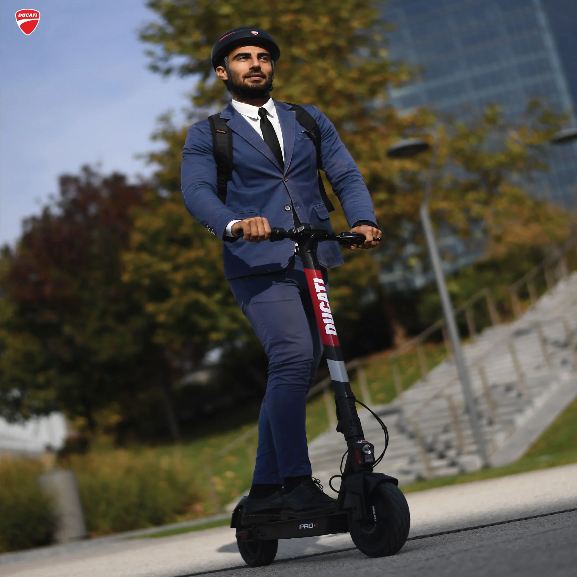 Man in a blue suit riding a Segway in an urban setting