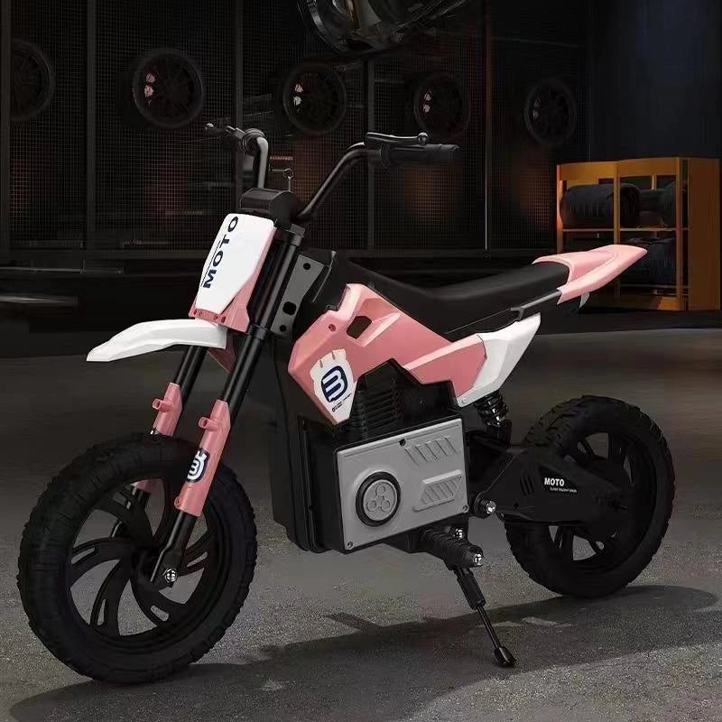 Pink and black children's motorcycle on a dark background