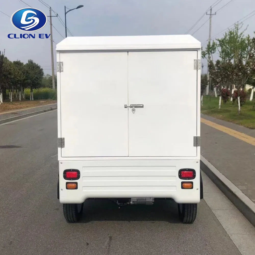 ocean cartz rear view of a white enclosed electric delivery vehicle with the cargo doors closed and securely latched, parked on a street. This image highlights the back of the electric utility truck's large, box-style rear cargo box, with bright red and orange taillights visible. The last-mile delivery NEV is shown outdoors, emphasizing its commercial and logistical purpose.